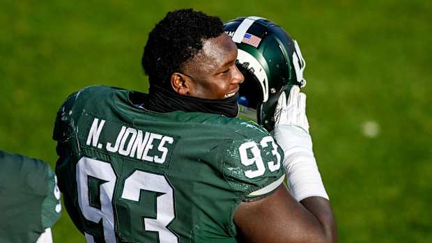 Michigan State's Naquan Jones talks with teammates on the sideline during the third quarter in the game against Indiana on Saturday, Nov. 14, 2020, at Spartan Stadium in East Lansing.